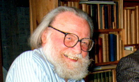 Portrait of Ray Watkinson beside his library